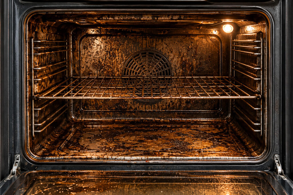 Dirty oven before professional cleaning in Chorlton, Manchester